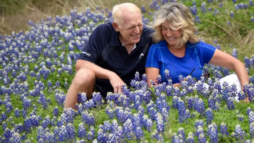 Kay and Jack, laughing together in a field of bluebonnets